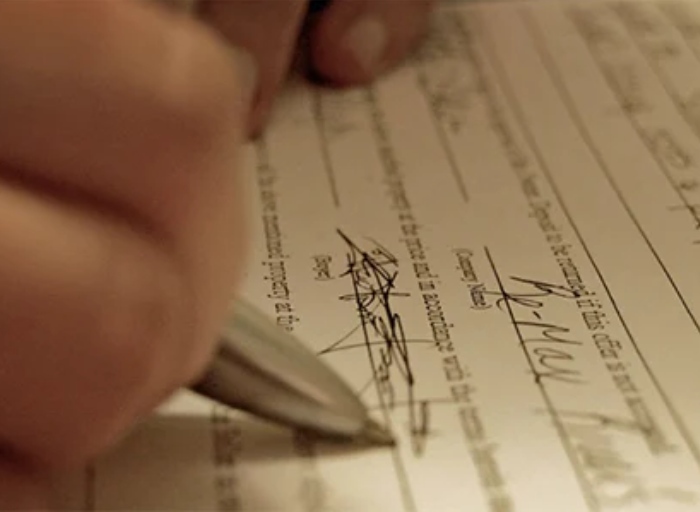 Persona firmando un documento